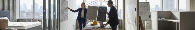 generate-an-image-showing-a-hotel room, restaurant and office space, that is still in the process of construction-where an architect is presenting samples of wallcovering to-to-a-client or investor
